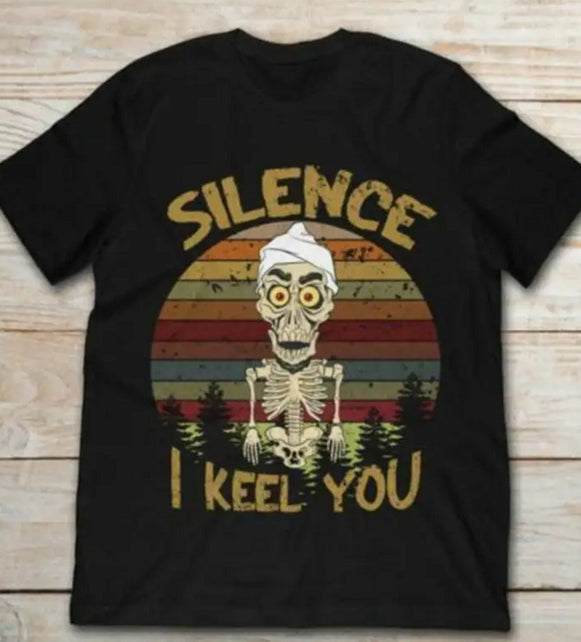 Black t-shirt with skeleton graphic and 'Silence I Keel You' text on a wooden surface